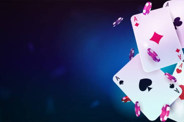 Casino playing cards with poker chips on blue blurred background